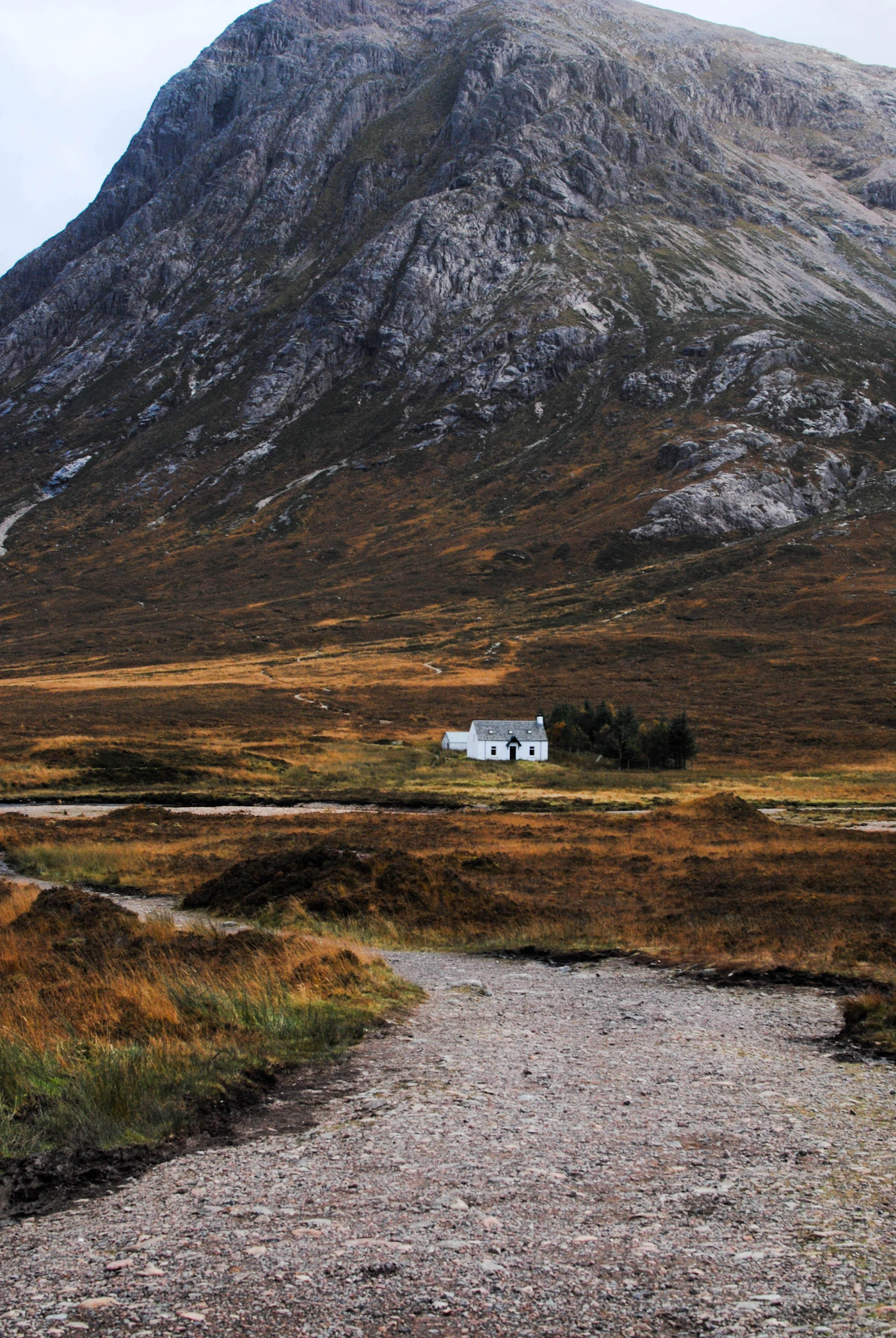 A small white cottage beneath the mountains of Glencoe